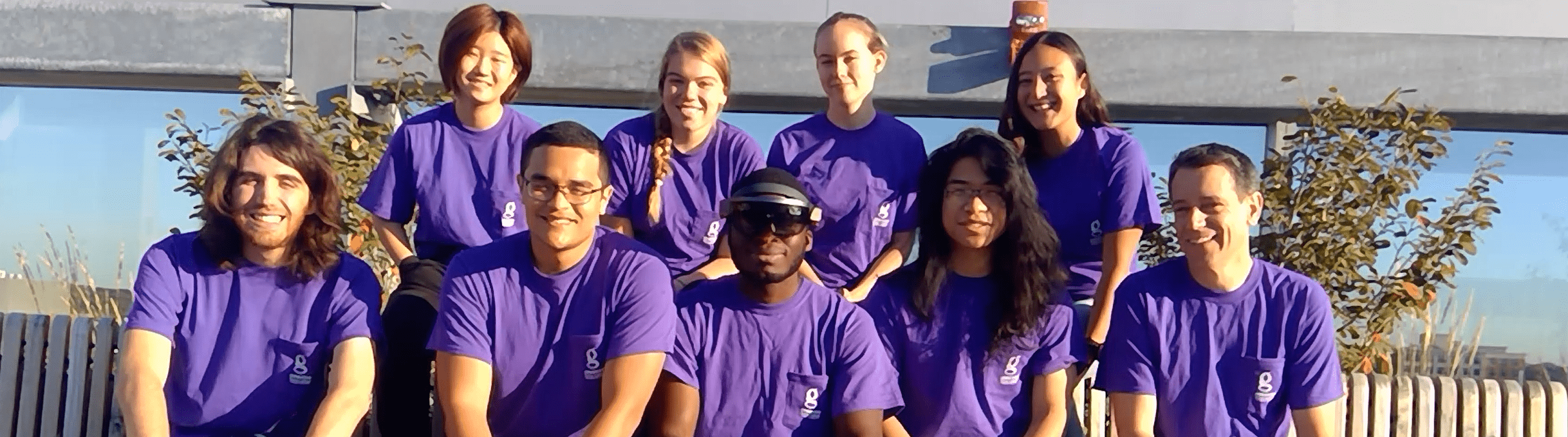 Group of Gemstone students outside, wearing matching purple tshirts