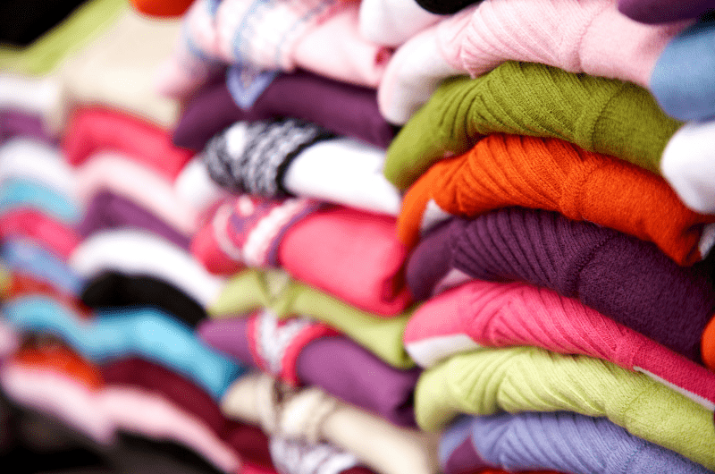 stacks of sweaters and tops