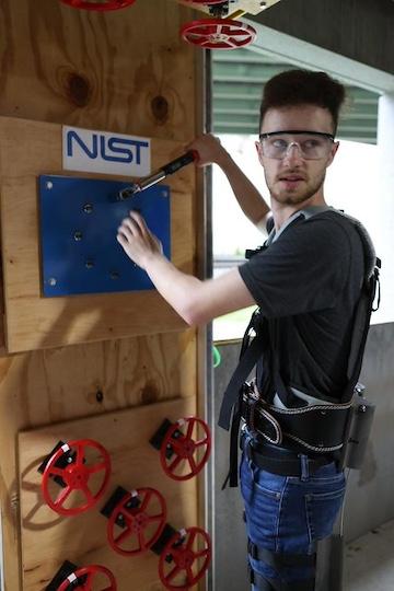 Photo of Nick Salantri wearing exoskeleton prototype