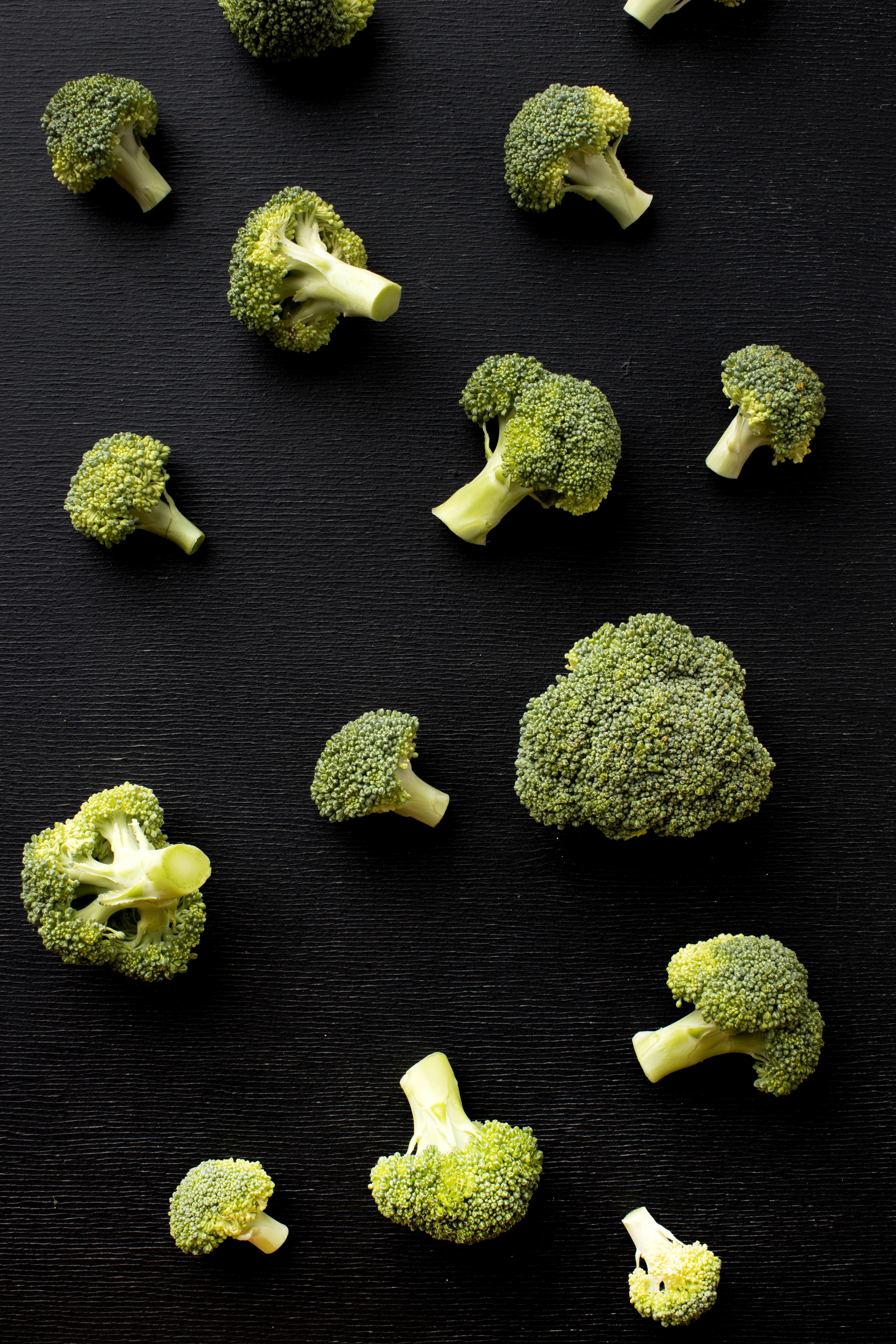 Broccoli spread out on black tabletop