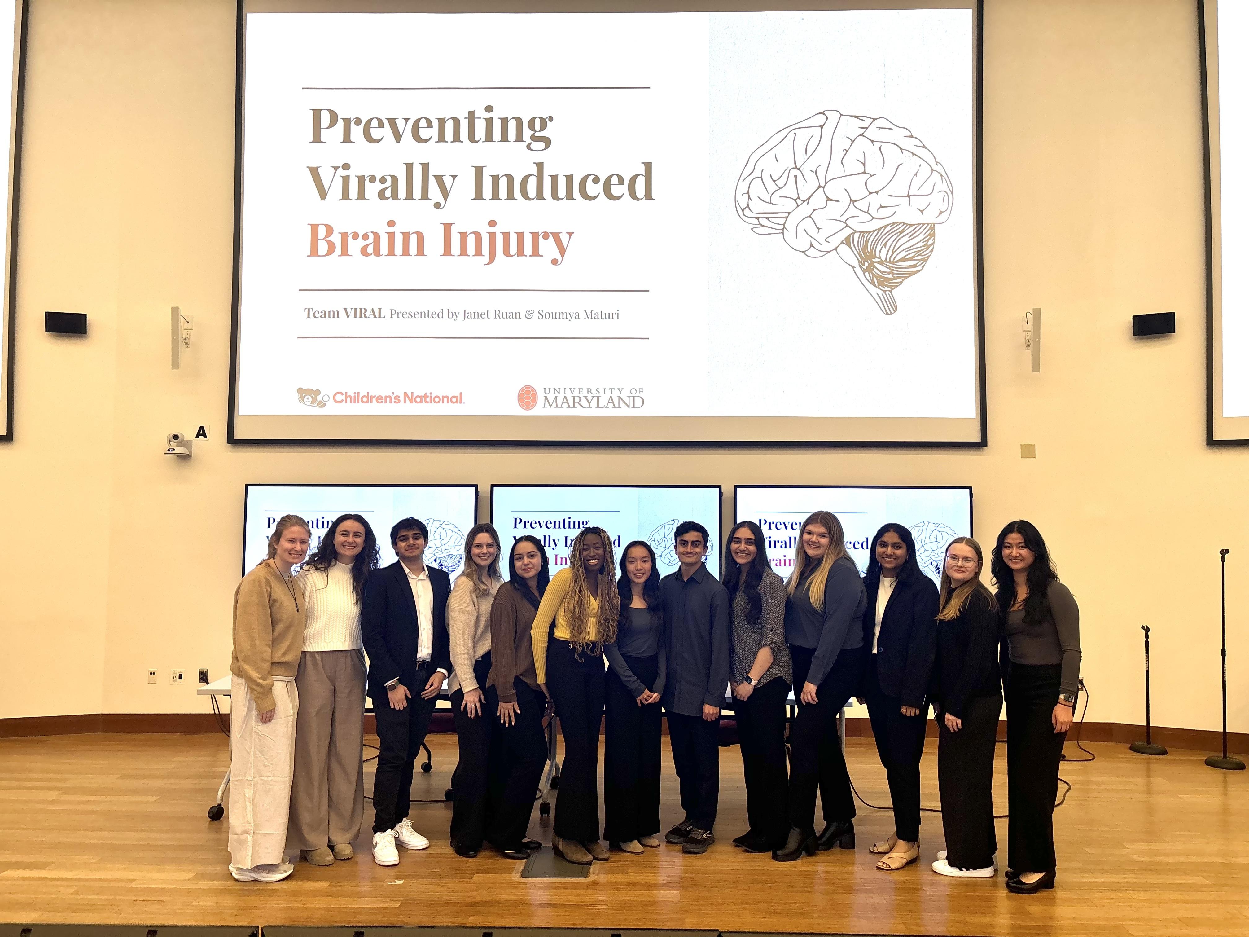 Team VIRAL in front of presentation slide that reads "Preventing Virally Induced Brain Injury" 