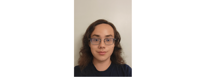 Photo of Avery Parker wearing a black shirt against a beige backdrop