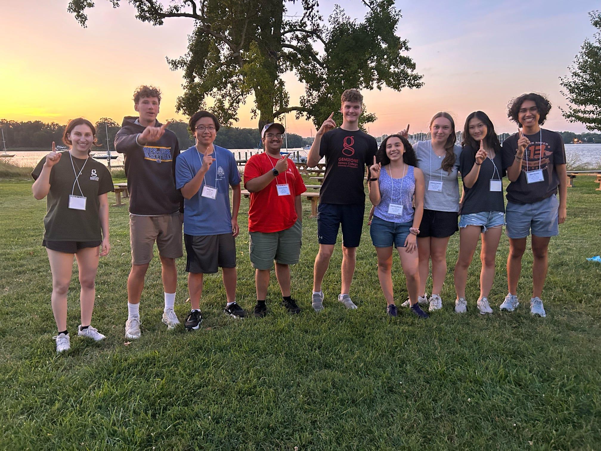 Group of students posing on lawn for photo