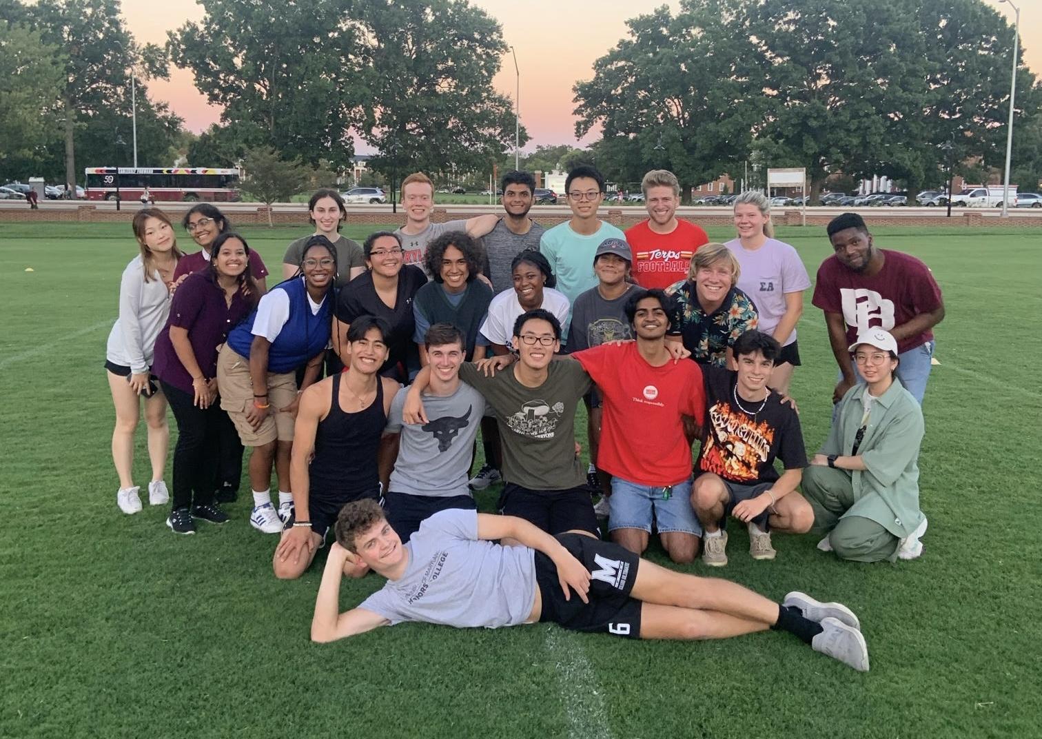 Group of students posing on lawn for photo