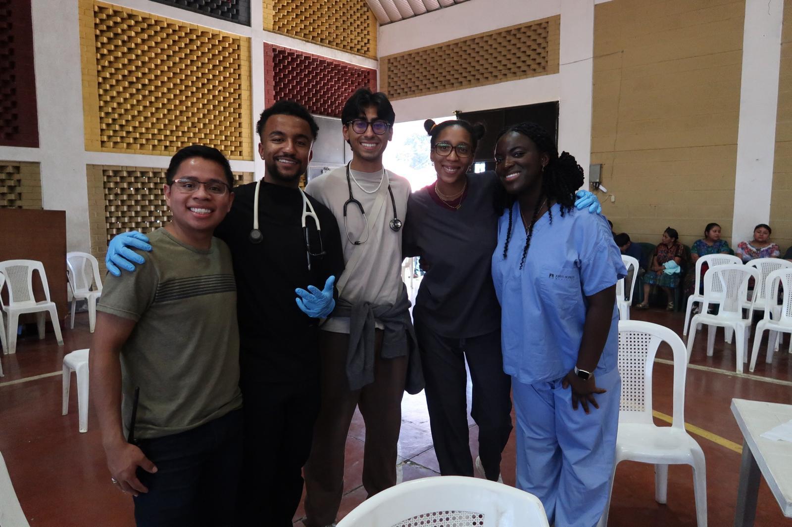 Gemstone student standing with four other students wearing various medical gear 