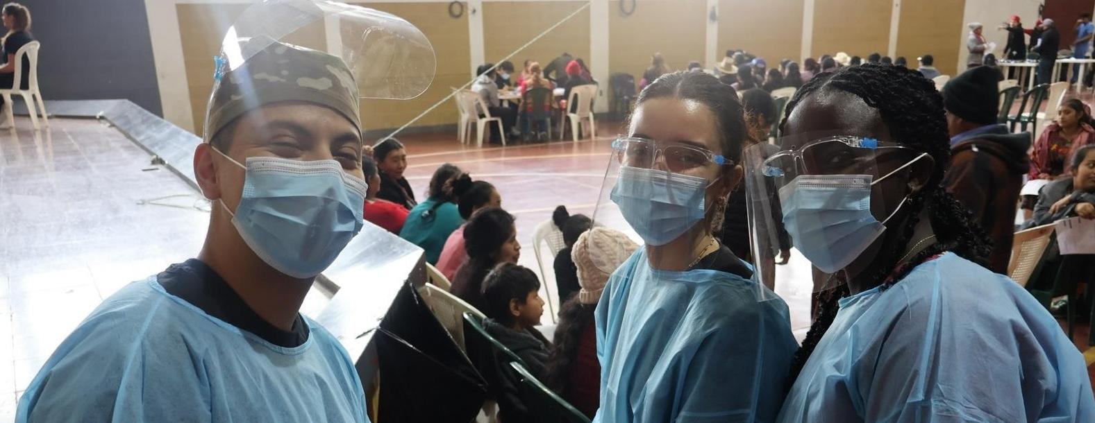 Three students wearing personal protective gear