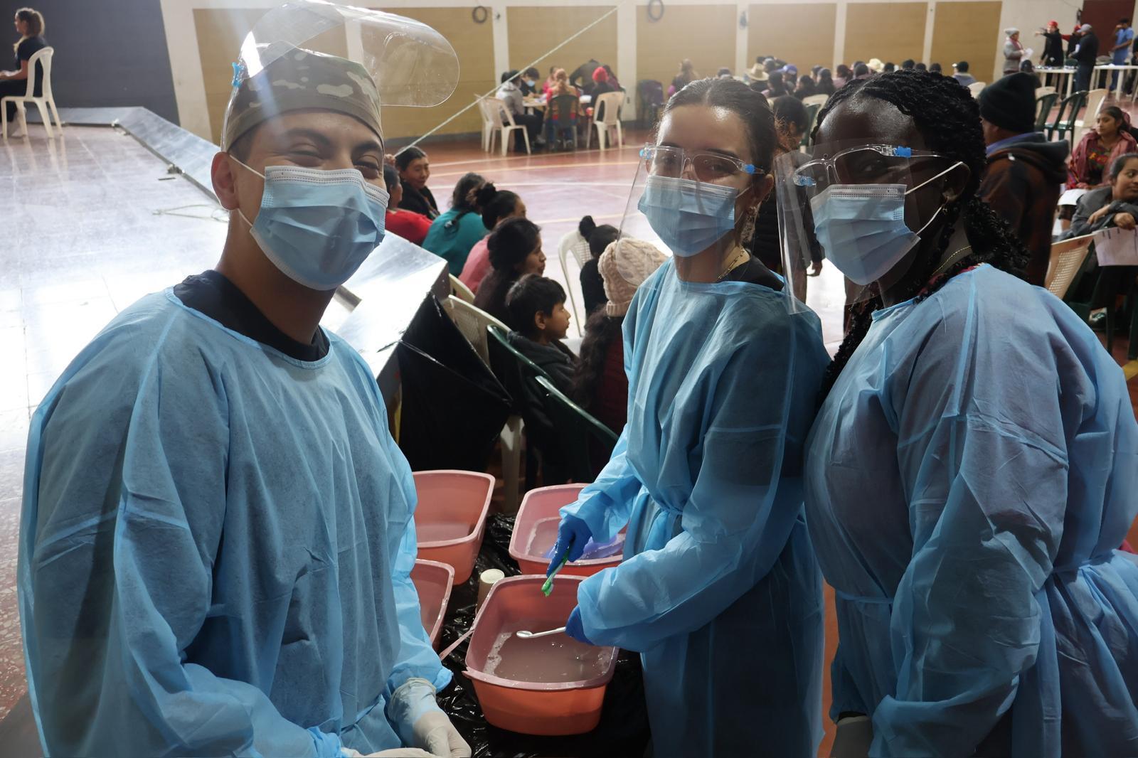 Three students wearing personal protective gear