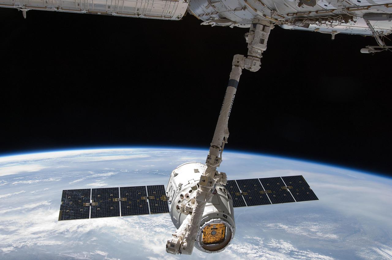 White and black satellite in space