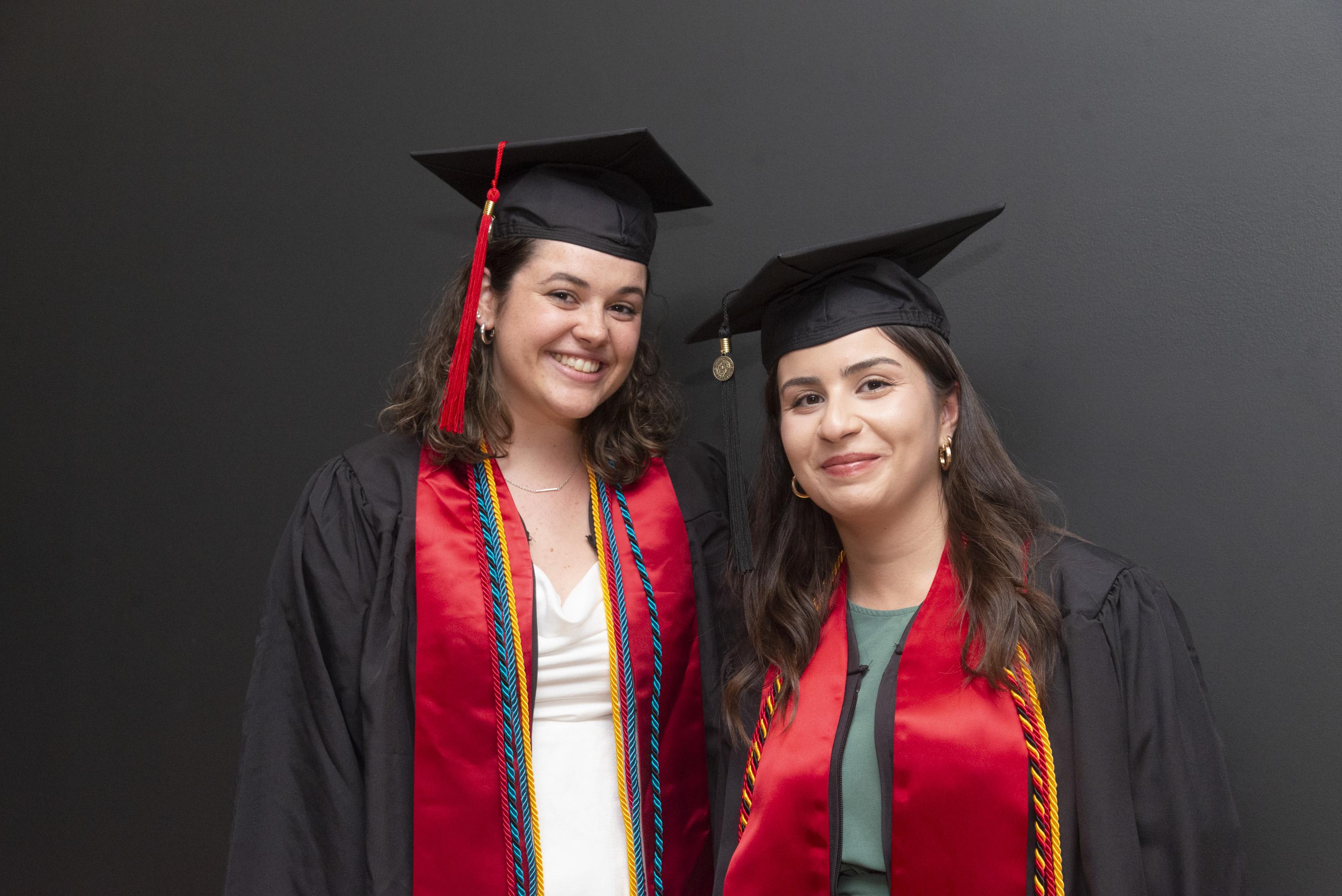 Two Gemstone students wearing graduation caps and gowns