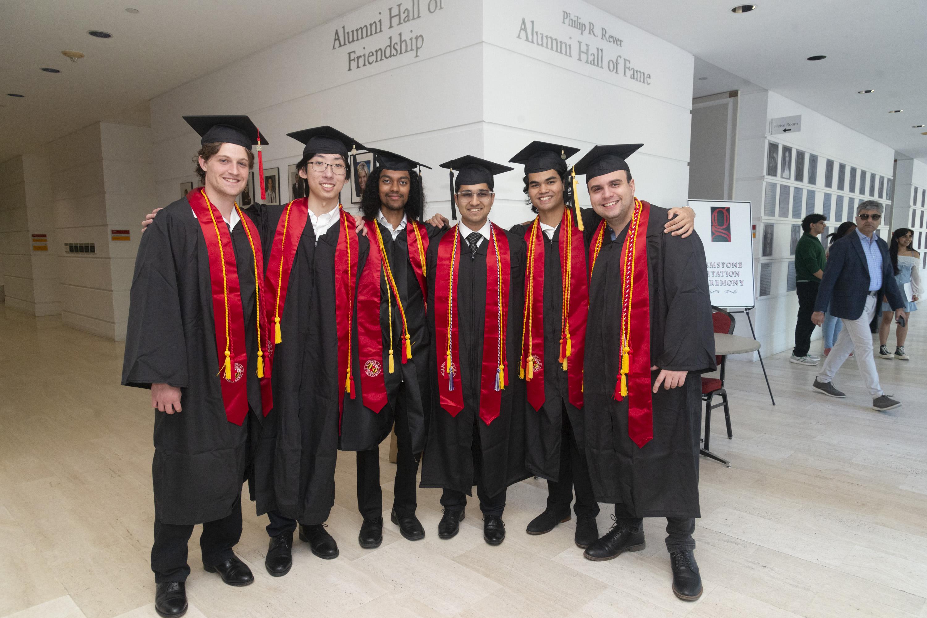 Six Gemstone students wearing graduation caps and gowns