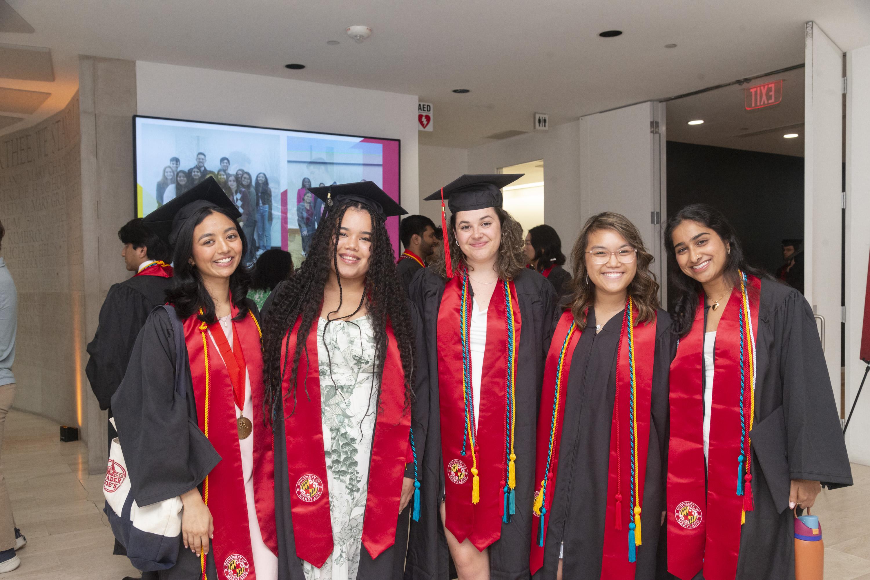 Five Gemstone students wearing graduation caps and gowns