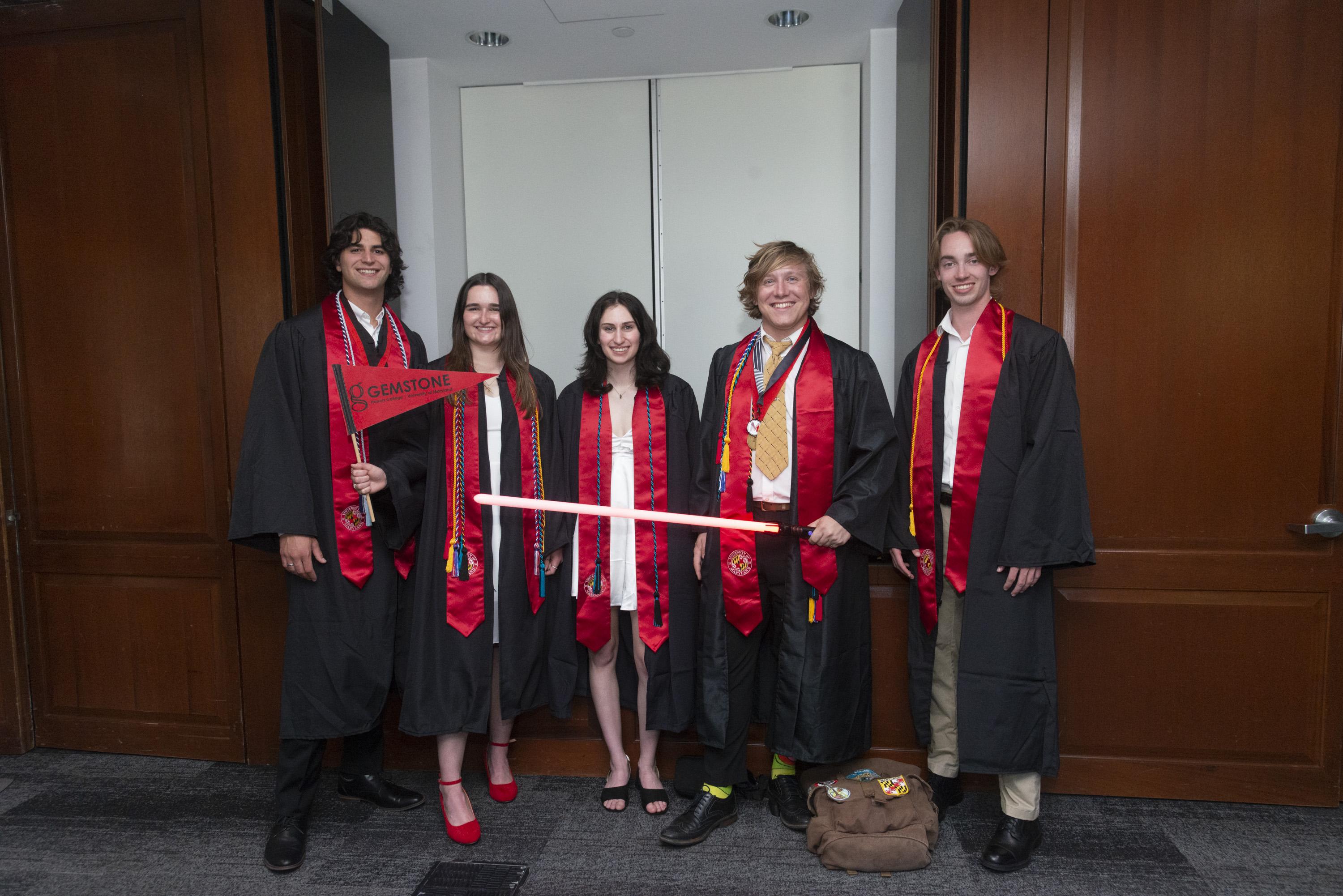 Five Gemstone students wearing graduation caps and gowns