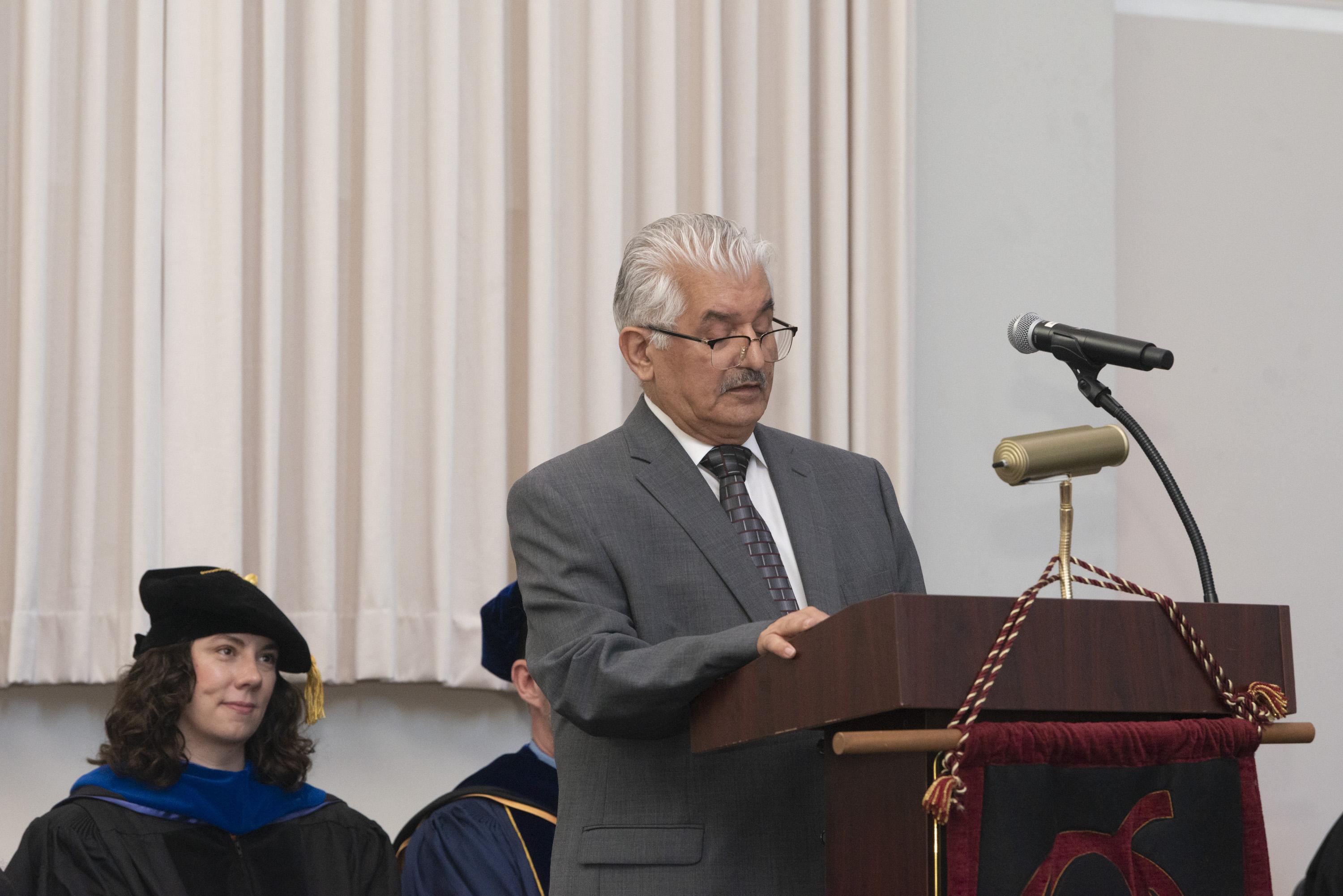 Gemstone parent, Dr. Fadul, giving a speech at a podium