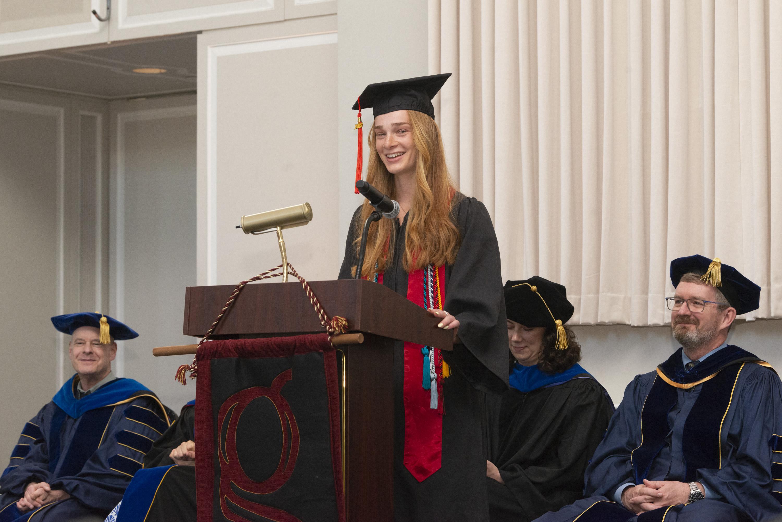 Gemstone student, Talya Simcox, giving a speech at the podium