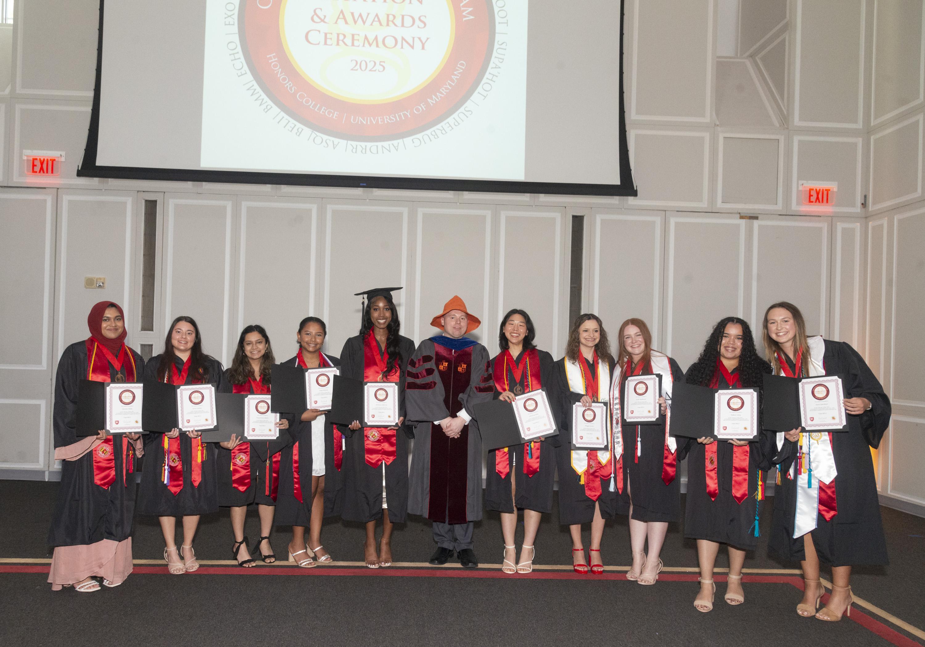 Gemstone students and their faculty mentor wearing graduation regalia