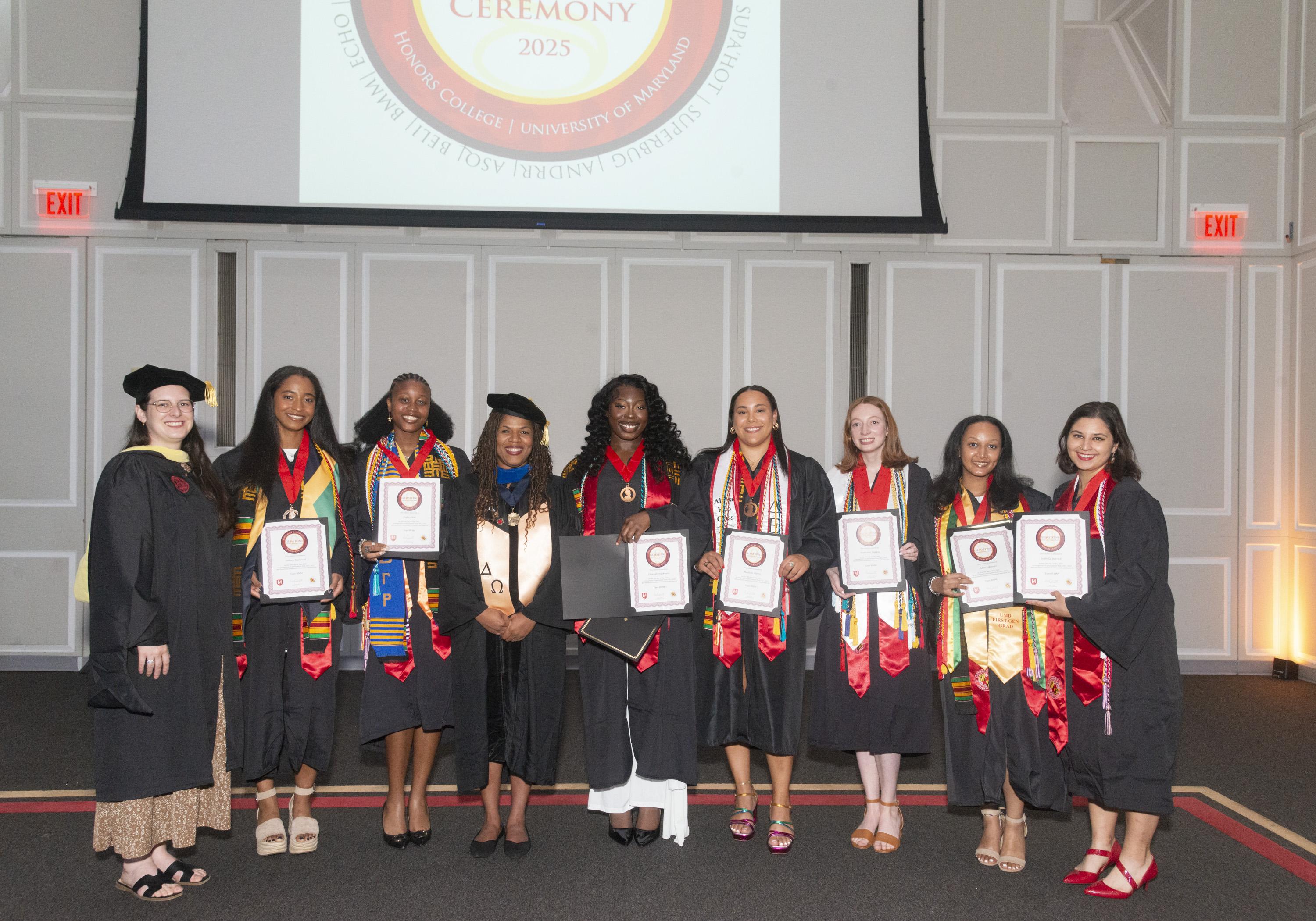 Gemstone students and their faculty mentor wearing graduation regalia