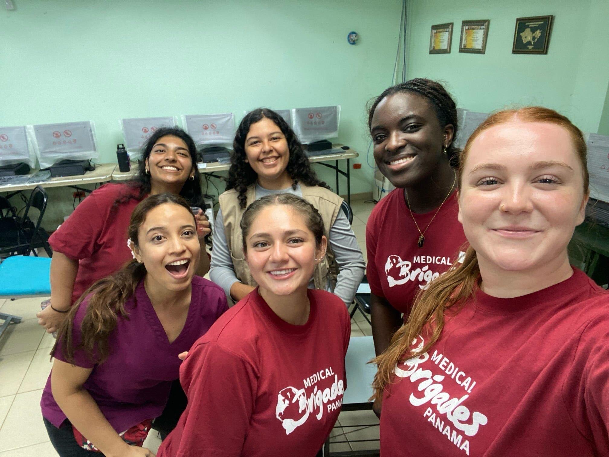 UMD Global Brigades Students wearing red tshirts and scrubs