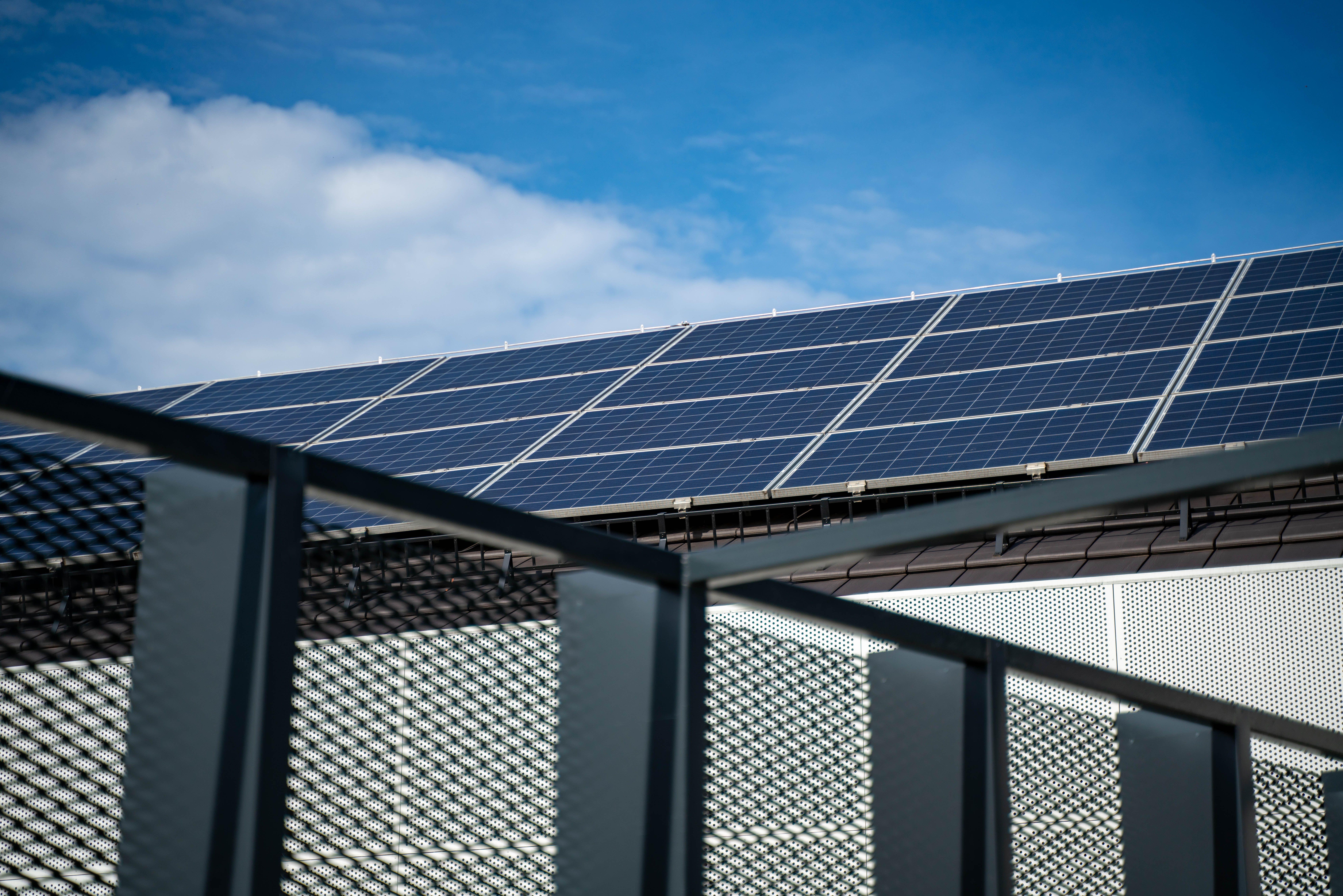 Solar panels on a roof of a building behind a gate